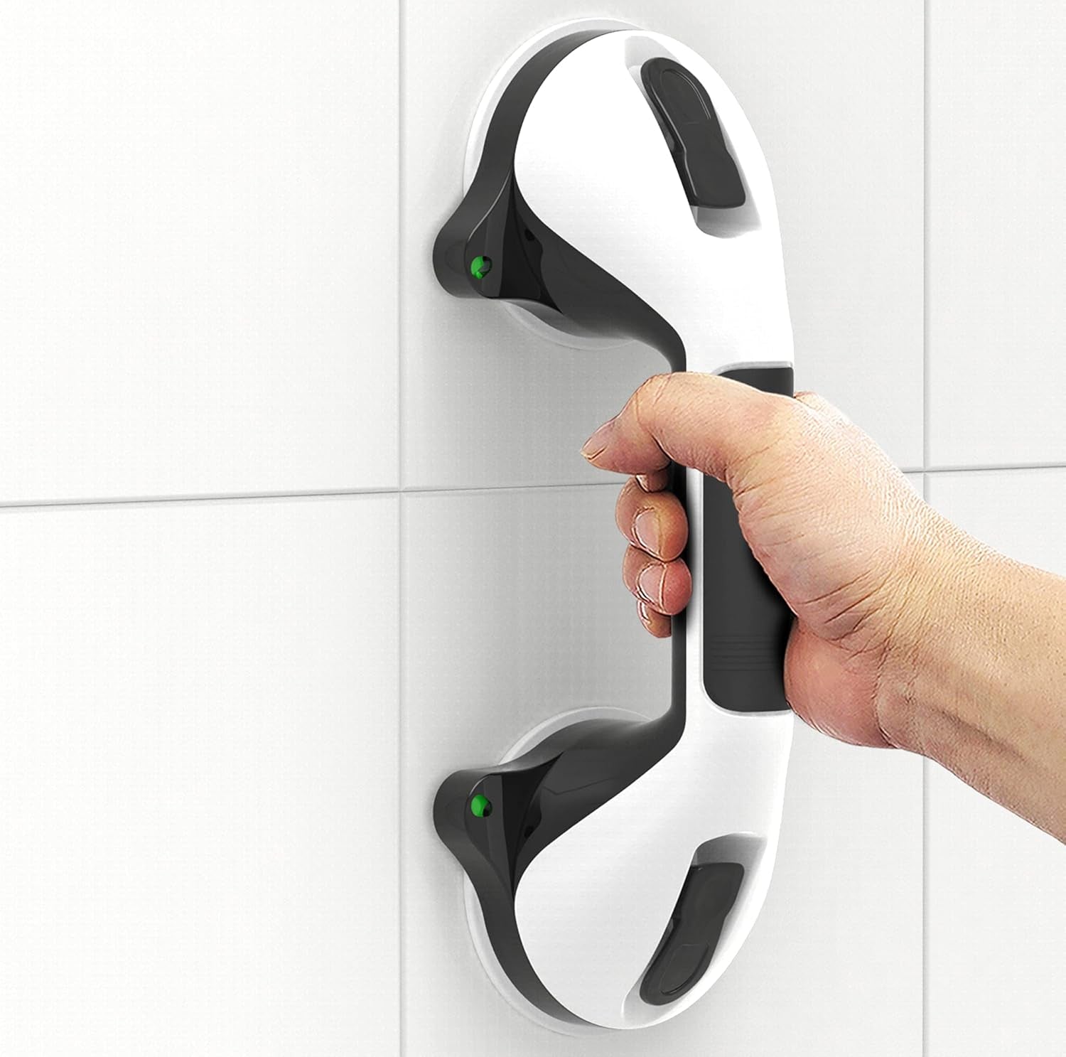 Hand holding a modern door handle on a tiled wall
