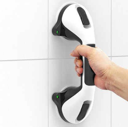 Hand holding a modern door handle on a tiled wall