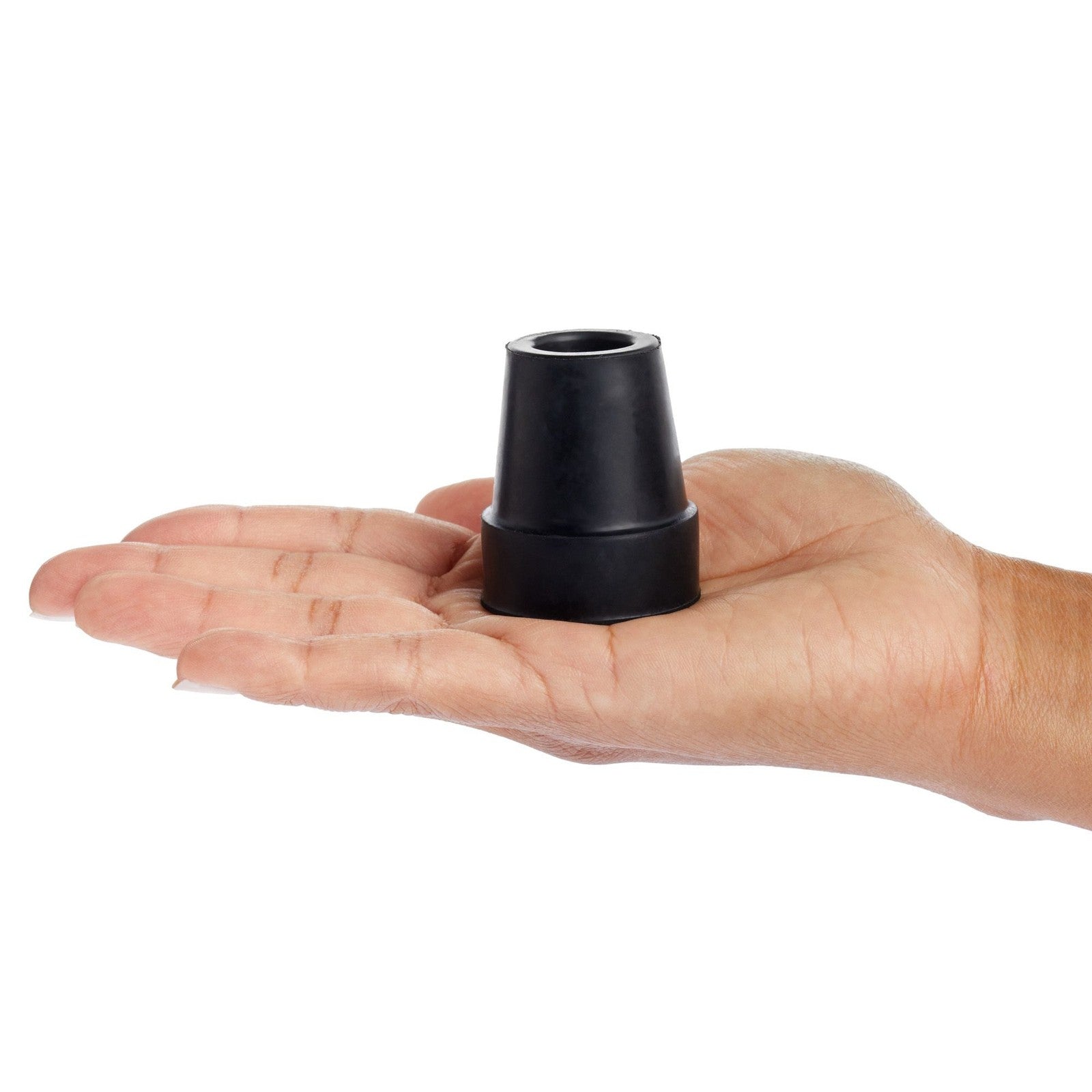 Black cone-shaped object held in a hand on a white background

