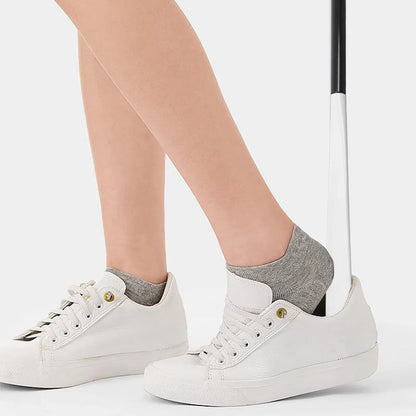 User applying socks or shoes with multi-function dressing aid. Ideal for seniors and post-surgery recovery.