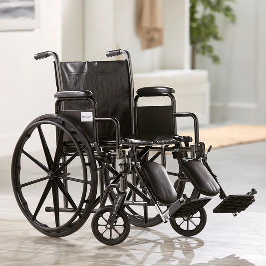 Black wheelchair on a light wooden floor with a blurred background

