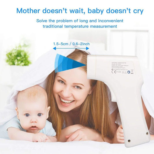 Woman holding a baby with a temperature measurement device on her forehead, set against a white background.