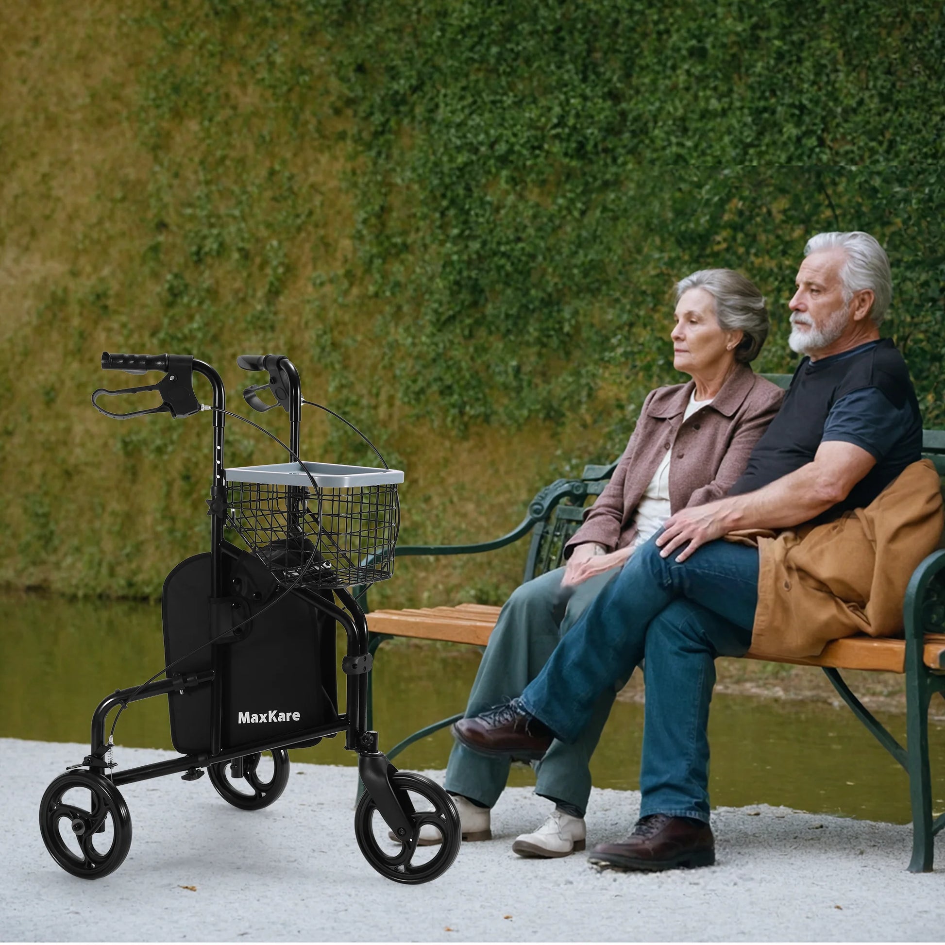 Two elderly people sitting on a bench next to a MaxKare walker.