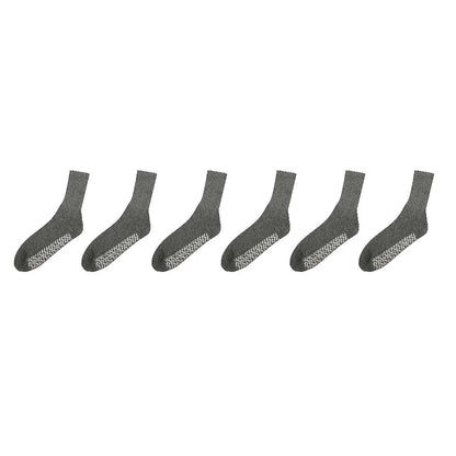 Set of six gray socks with textured sole on a white background